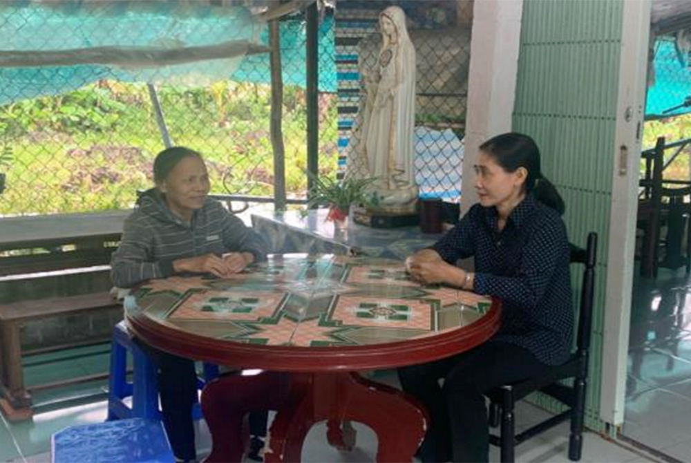 Sr. Mary Nguyen Thi My, left, meets with Sister Chuong of the Daughters of the Mother of God, about a report for a project on water purification. Since 2000, Sr. Mary Nguyen Thi My has worked with Vietnamese sisters, using her knowledge of English to help