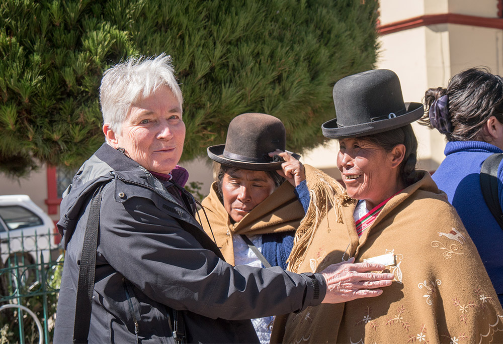 In this 2016 photo, Maryknoll Sr. Patricia Ryan speaks with Lucila Ticona Vda. de Laura and other Aymara community leaders, in an Acción de Amparo, at Plaza de Armas, Puno City, Puno Department, Peru. (Courtesy of Maryknoll Magazine/Nile Sprague)