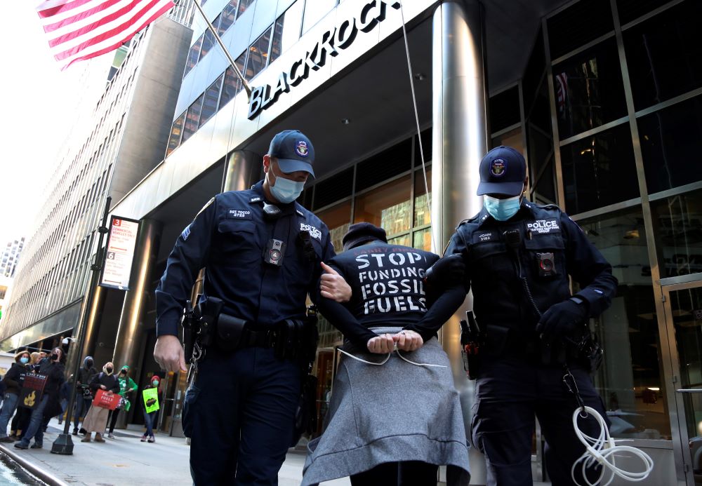 Climate activist Rev. Chelsea McMillan, center, is arrested Oct. 18 after an interfaith demonstration outside the headquarters of BlackRock, a multinational investment management corporation, in New York City. (AP/Jessie Wardarski)