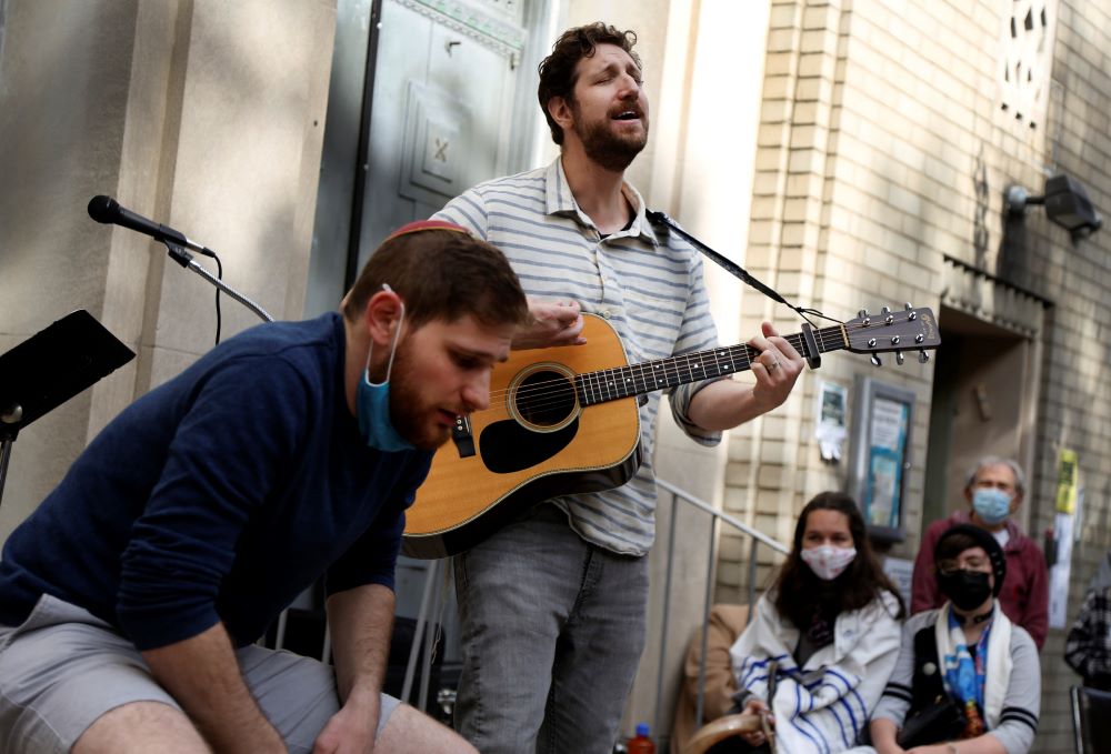 Jonathan Wasserman, left, and Adam Masser perform the Tishrei Niggun, a wordless Jewish melody, during the Faiths for Climate Justice global mobilization event Oct. 17. (AP/Jessie Wardarski)