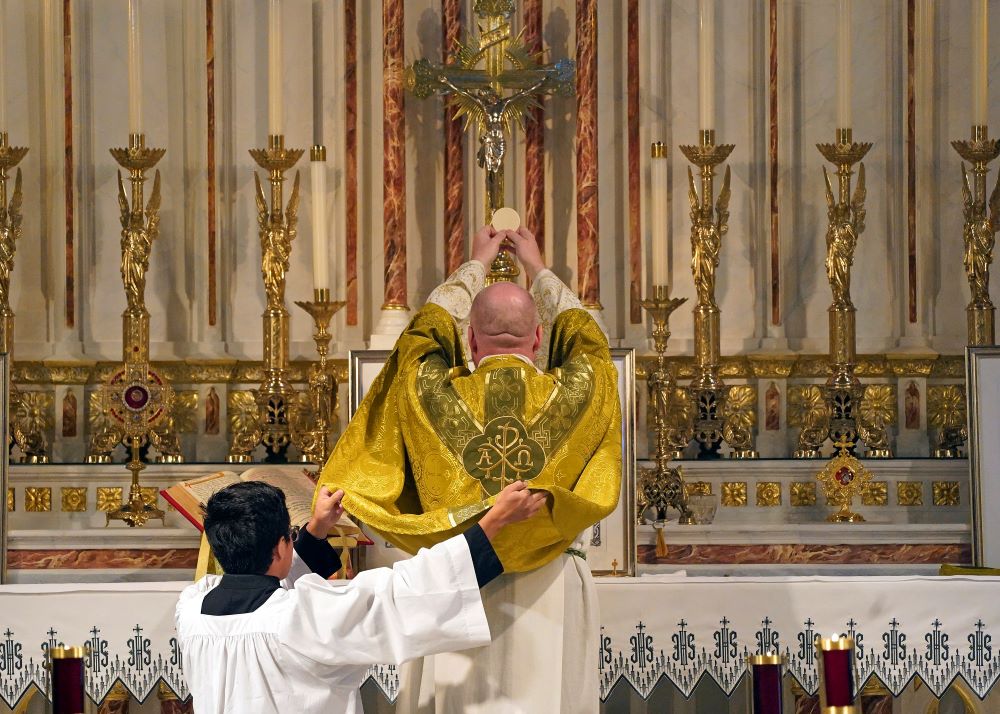 Fr. Stephen Saffron, parish administrator, elevates the Eucharist during a traditional Latin Mass July 18, 2021, at St. Josaphat Church in the Queens borough of New York City. (CNS/Gregory A. Shemitz)
