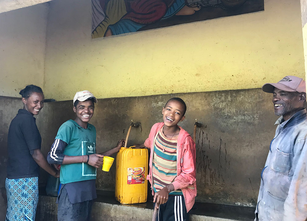 People in Ethiopia make use of a water source developed for their community. (Courtesy of Thérèse Hope Merandi)