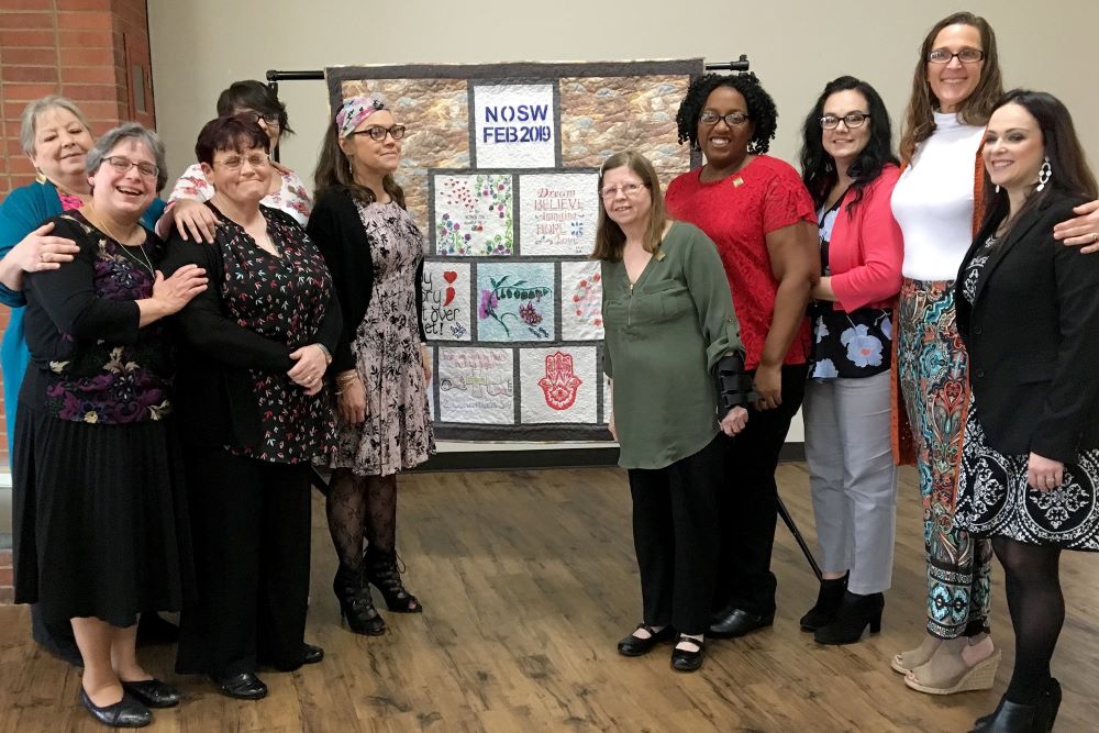 Sr. Robbie Pentecost (far left, front) is surrounded by graduates of the New Opportunity School's two-week residential program, where participants build self-esteem and learn critical life skills. (Courtesy of New Opportunity School for Women)