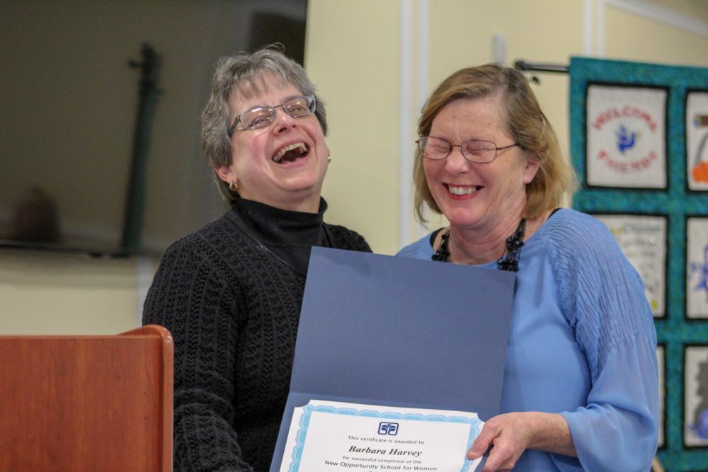 Sr. Robbie Pentecost (left), executive director of the New Opportunity School for Women in Berea, Kentucky, presents Barbara Harvey with a completion certificate from NOSW's two-week residential program in 2018. 