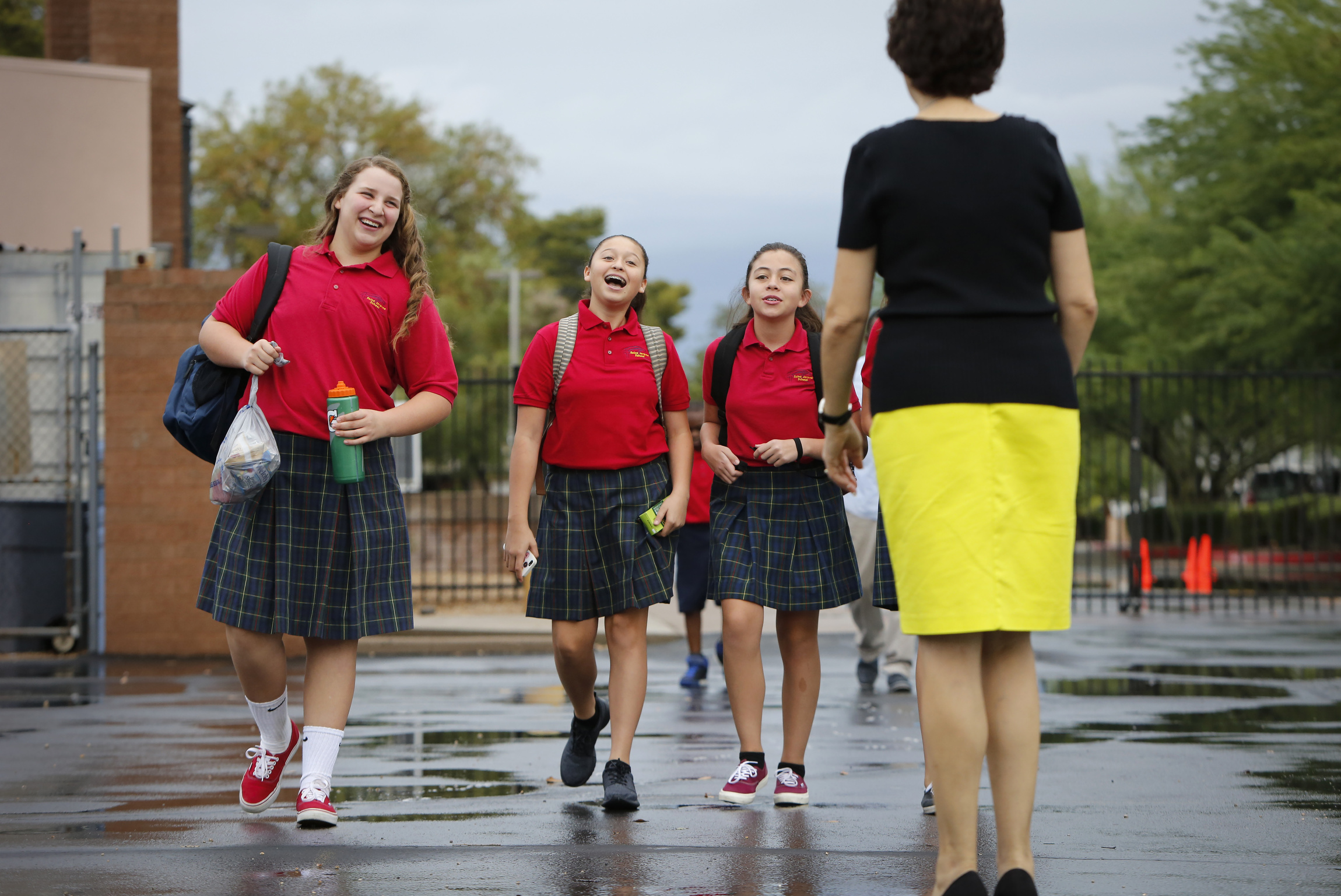 Girls greet a teacher as they arrive for class at St. Jerome Catholic School in Phoenix. More than 1.9 million U.S. students were returning to Catholic elementary, middle and secondary schools this academic year, according to the National Catholic Educati Girls greet a teacher as they arrive for class at St. Jerome Catholic School in Phoenix. More than 1.9 million U.S. students were returning to Catholic elementary, middle and secondary schools this academic year, according to the National Catholic Educati