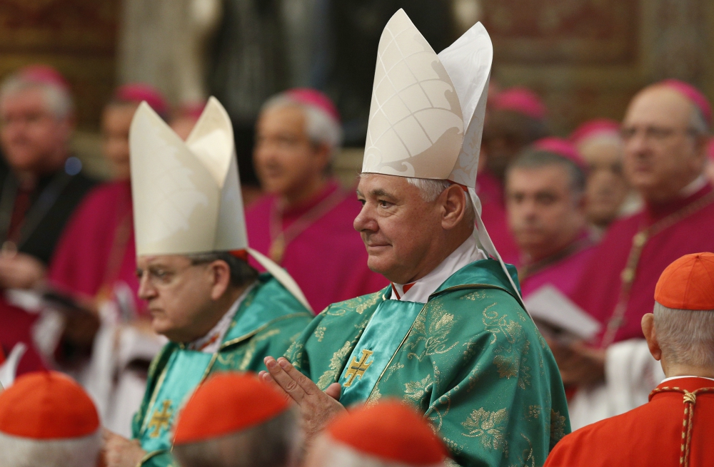 Cardinal Raymond Burke and Cardinal Gerhard Müller arrive in procession for a Mass celebrated by Pope Francis to open the Synod of Bishops on the family in St. Peter's Basilica at the Vatican Oct. 5, 2014. (CNS/Paul Haring)