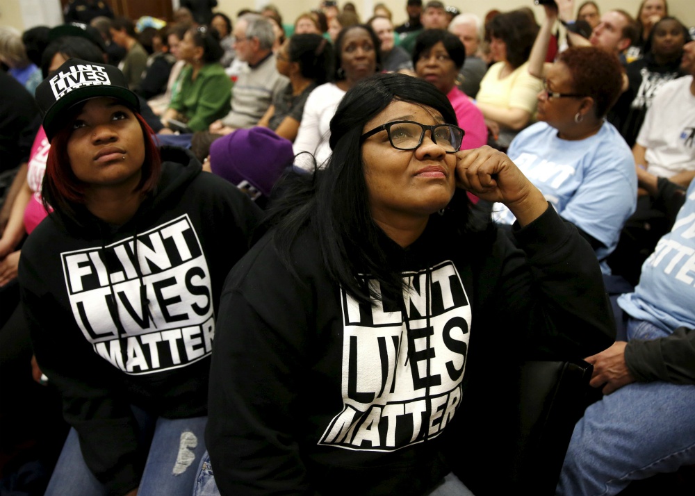 Residents of Flint, Michigan, watch a live feed of then-Gov. Rick Snyder and then-Environmental Protection Agency administrator Gina McCarthy testify March 17, 2016, in Washington at House hearing on the water crisis in Flint. (CNS/Reuters/Kevin Lamarque) Residents of Flint, Michigan, watch a live feed of then-Gov. Rick Snyder and then-Environmental Protection Agency administrator Gina McCarthy testify March 17, 2016, in Washington at House hearing on the water crisis in Flint. (CNS/Reuters/Kevin Lamarque)