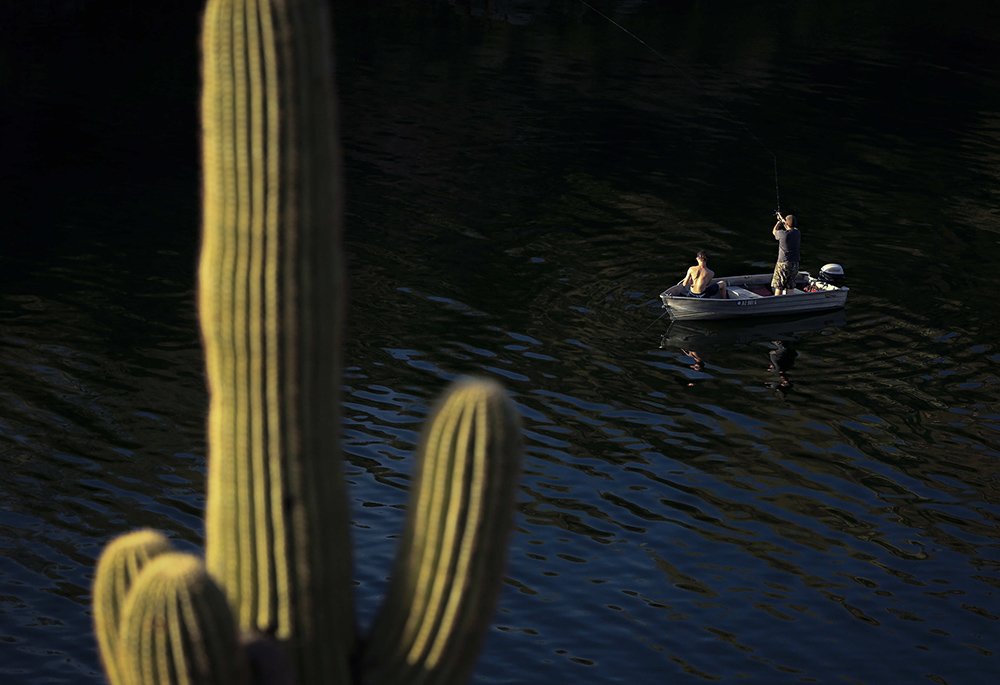 Men fish in Saguaro Lake in the Tonto National Forest outside Mesa, Arizona, in March 2016. (CNS/Nancy Wiechec)