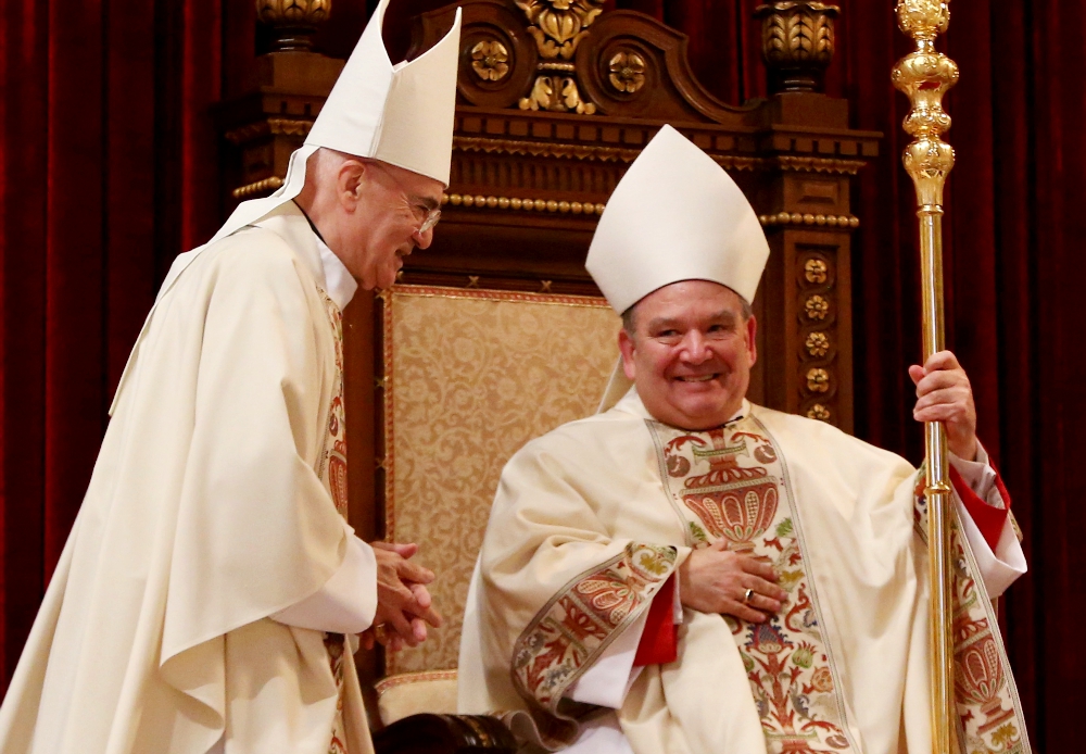 Archbishop Bernard Hebda takes the cathedra during his installation Mass May 13, 2016, at the Cathedral of St. Paul in St. Paul, Minnesota. Archbishop Carlo Maria Viganò, former nuncio to the U.S., is at left. (CNS/The Catholic Spirit/Dave Hrbacek)