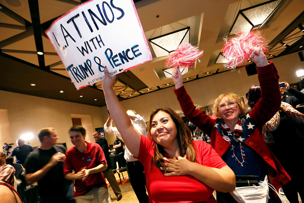 Attendees at a Republican Party event in Phoenix watch as President-elect Donald Trump gives his acceptance speech in New York in the early morning hours of Nov. 9, 2016. (CNS/Reuters/Nancy Wiechec)