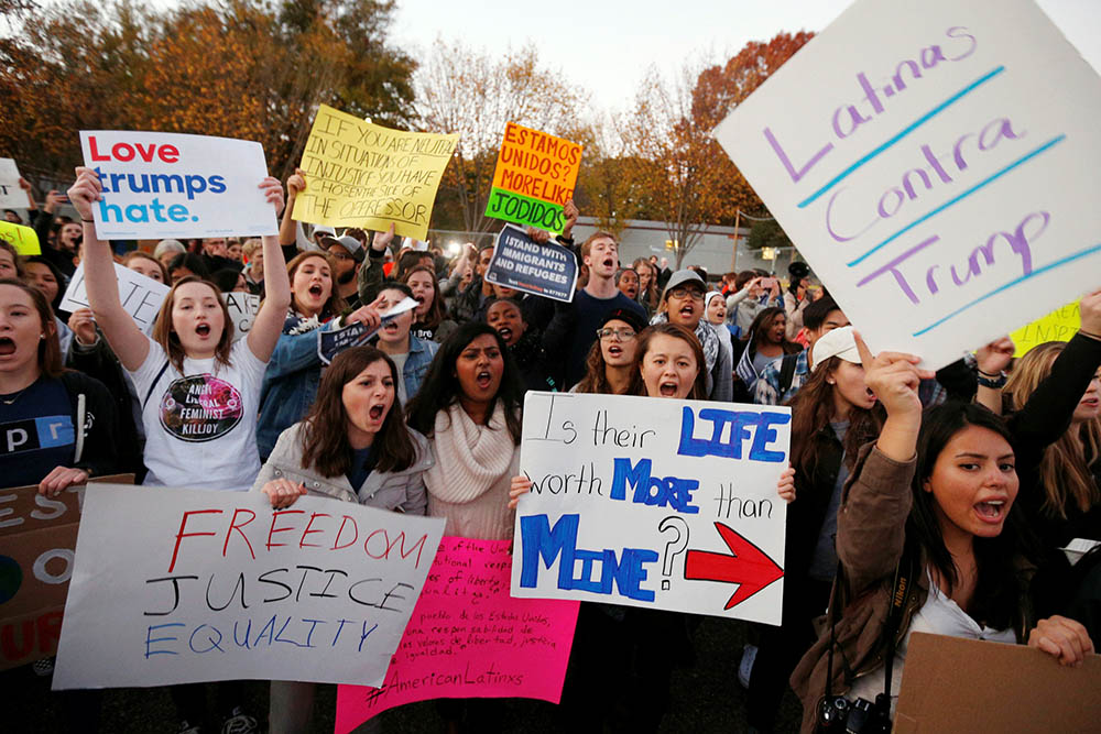 Demonstrators shout and hold signs in front of the White House in Washington Nov. 10, 2016, following President-elect Donald Trump's victory in the Nov. 8 election. (CNS/Reuters/Kevin Lamarque)