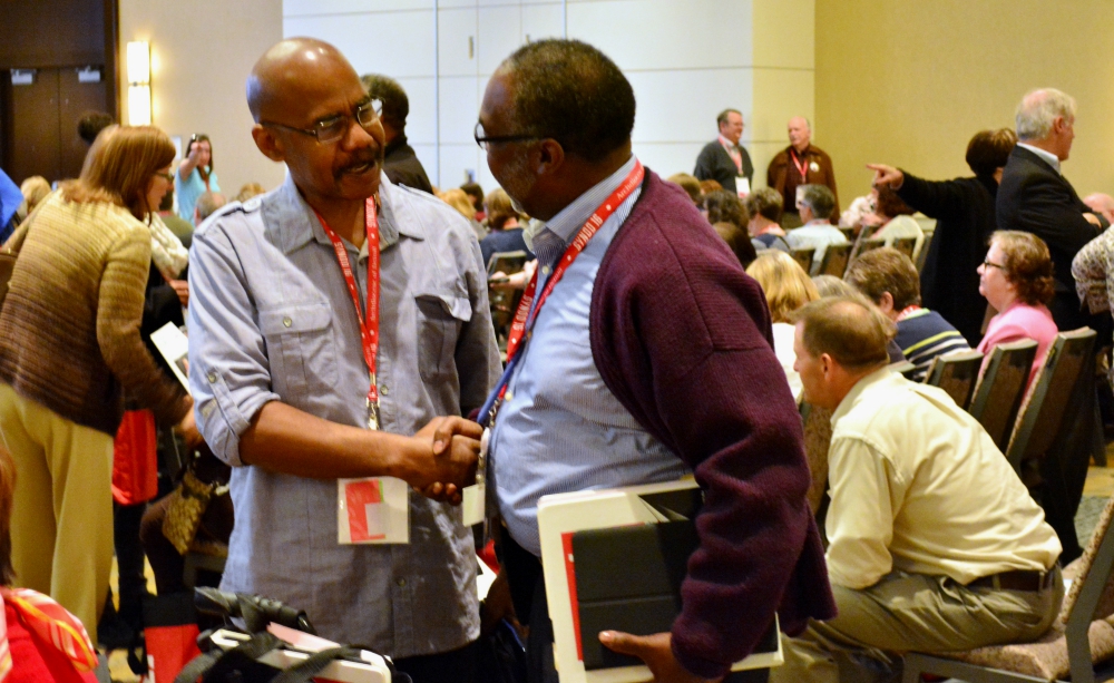 Synod members greet one another during the opening session of the Detroit Archdiocese's synod in November 2016. (CNS/The Michigan Catholic/Mike Stechschulte) 