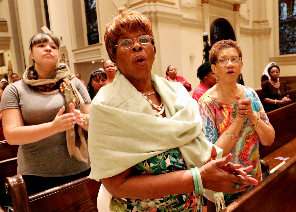 Women sing during a Mass for solidarity and peace Aug. 24, 2017, at St. James Cathedral Basilica in Brooklyn, New York. (CNS/Gregory A. Shemitz)