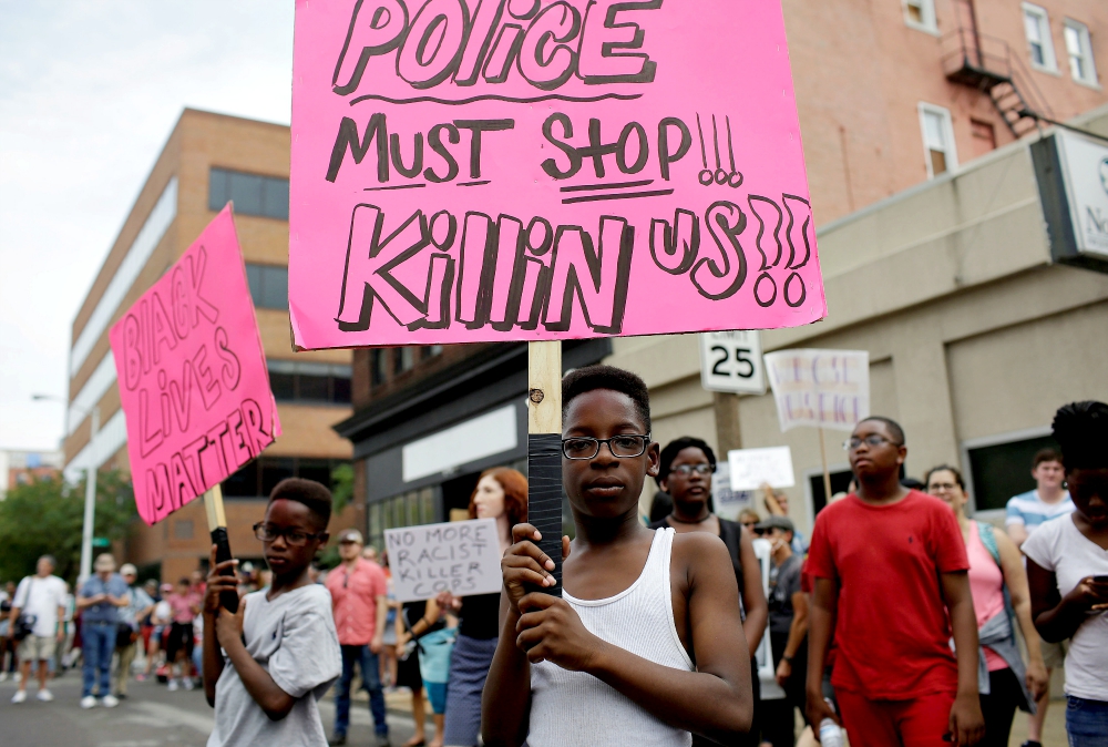 Young people hold signs during September 2017 protests after a not-guilty verdict in the murder trial of former St. Louis police officer Jason Stockley, charged with the 2011 fatal shooting of Anthony Lamar Smith, who was black. Stockley is white. (CNS) Young people hold signs during September 2017 protests after a not-guilty verdict in the murder trial of former St. Louis police officer Jason Stockley, charged with the 2011 fatal shooting of Anthony Lamar Smith, who was black. Stockley is white. (CNS)