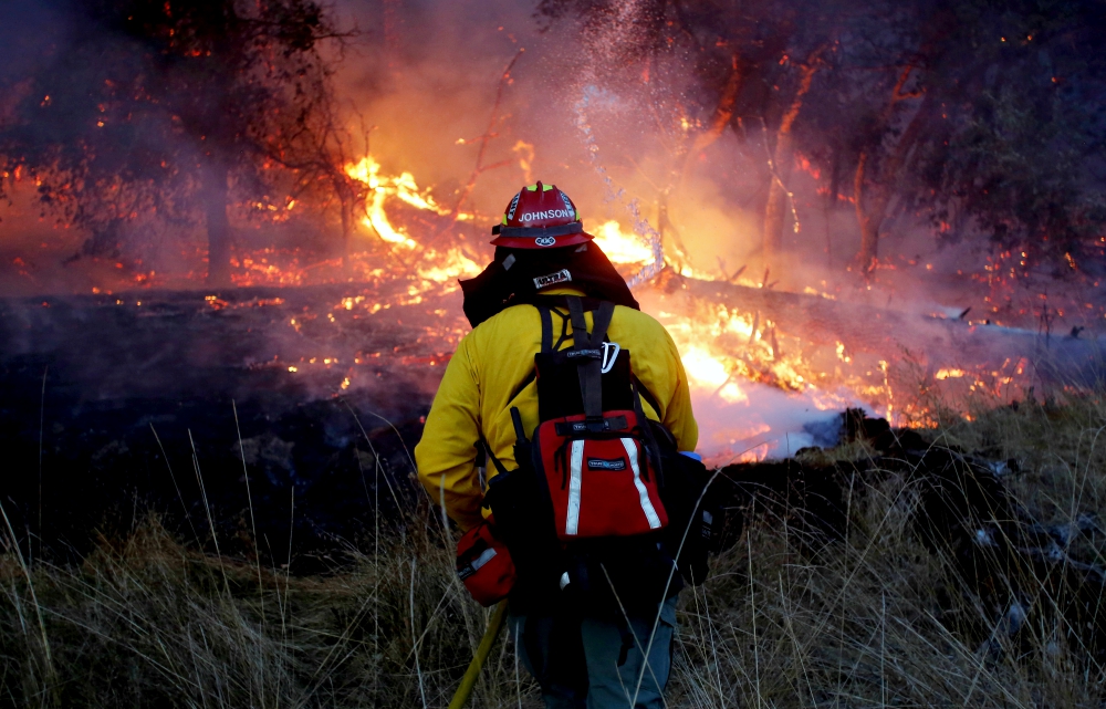 A firefighter battles a wildfire Oct. 14 near Santa Rosa, California. (CNS/Reuters/Jim Urquhart)