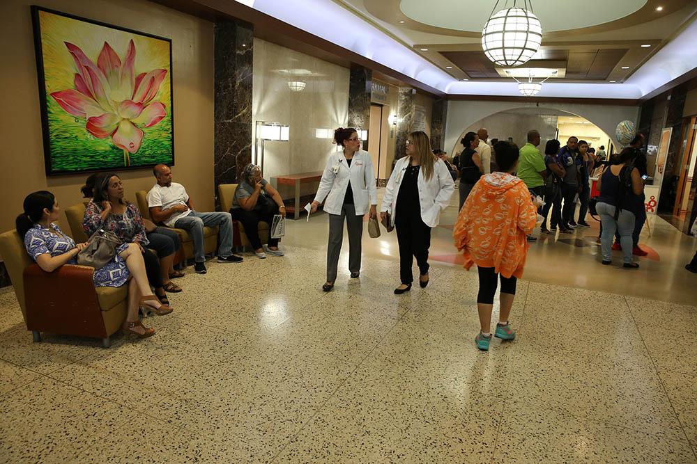 Medical staff and others walk through the hallway of Mutual Help Catholic Hospital in San Juan, Puerto Rico, in 2017. (CNS/Bob Roller)