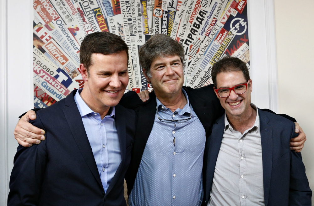 Chilean clerical sex abuse survivors Juan Carlos Cruz, James Hamilton and José Andrés Murillo embrace after speaking to the media at the Foreign Press Association building in Rome May 2. (CNS/Paul Haring)