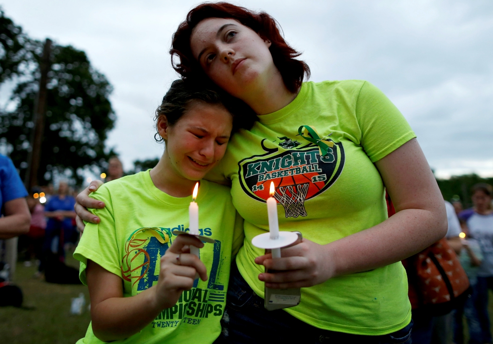 A young woman weeps during a vigil in memory of the victims killed in a shooting May 20 at Santa Fe High School in Texas. (CNS/Reuters/Jonathan Bachman)