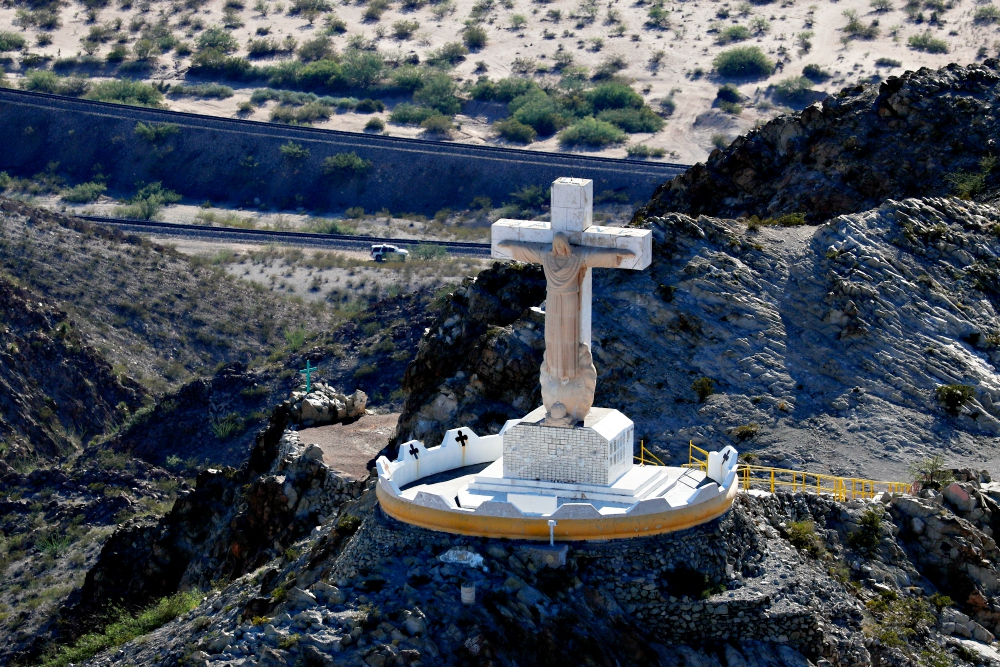 A U.S. Border Patrol truck drives along the border fence with Mexico and passes the Cristo Rey Statue on Mount Cristo in Sunland Park, New Mexico, June 18. (CNS/Reuters/Mike Blake)