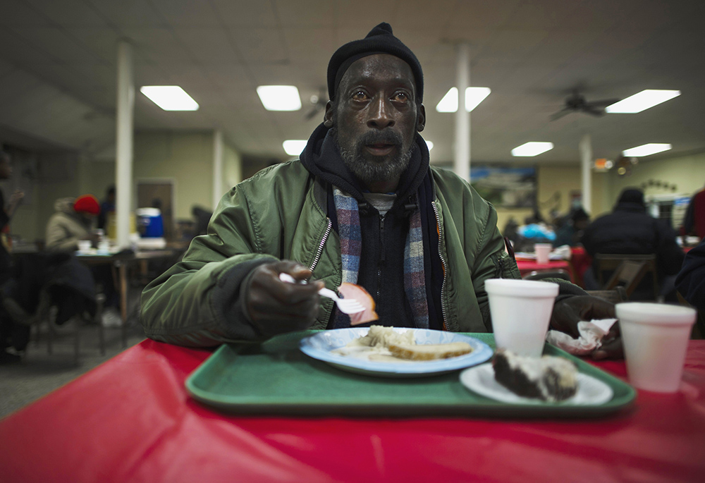 A man eats his lunch at a soup kitchen in the basement of St. Leo Catholic Church in Detroit. (CNS/Reuters/Mark Blinch)