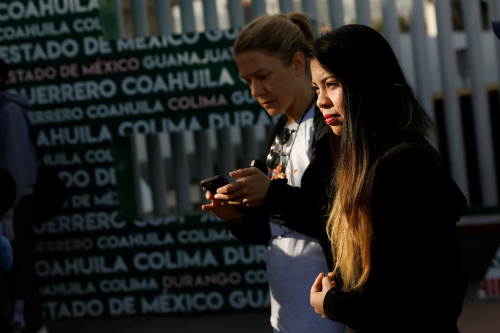 A woman waits for her number to seek asylum in the United States at the Chaparral border crossing in Tijuana, Mexico, Jan. 28. (CNS/Reuters/Shannon Stapleton)