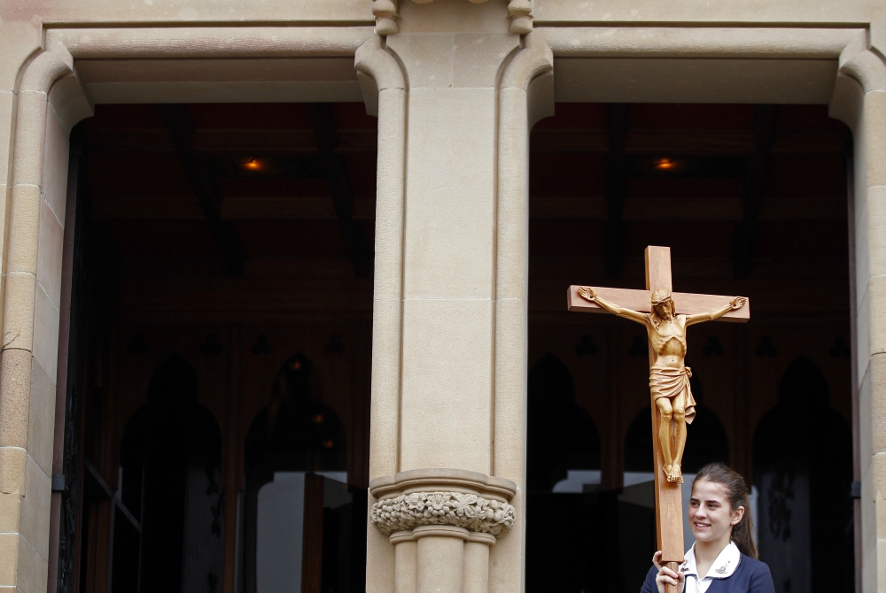 A young woman leaves St. Mary's Cathedral after a Mass in Sydney in 2013. (CNS/Reuters/Daniel Munoz)