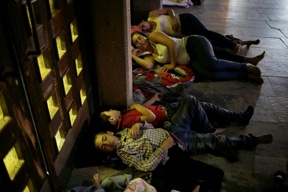 Central American migrants sleep outside Our Lady of Guadalupe Cathedral in Ciudad Juárez, Mexico, July 14. (CNS/Reuters/Jose Luis Gonzalez) Central American migrants sleep outside Our Lady of Guadalupe Cathedral in Ciudad Juárez, Mexico, July 14. (CNS/Reuters/Jose Luis Gonzalez)