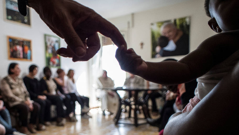 Pope Francis sits with women rescued from prostitution and their supporters at the Pope John XXIII Community in Rome Aug.12, 2016. (CNS photo/L'Osservatore Romano via Reuters)