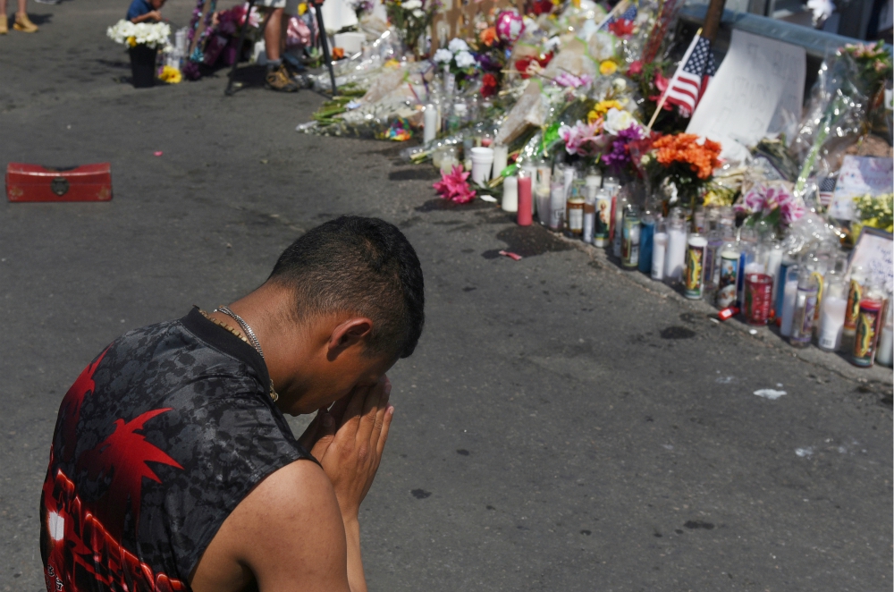 A man prays at a memorial Aug. 6, three days after a mass shooting at a Walmart store in El Paso, Texas. (CNS/Reuters/Callaghan O'Hare) A man prays at a memorial Aug. 6, three days after a mass shooting at a Walmart store in El Paso, Texas. (CNS/Reuters/Callaghan O'Hare)