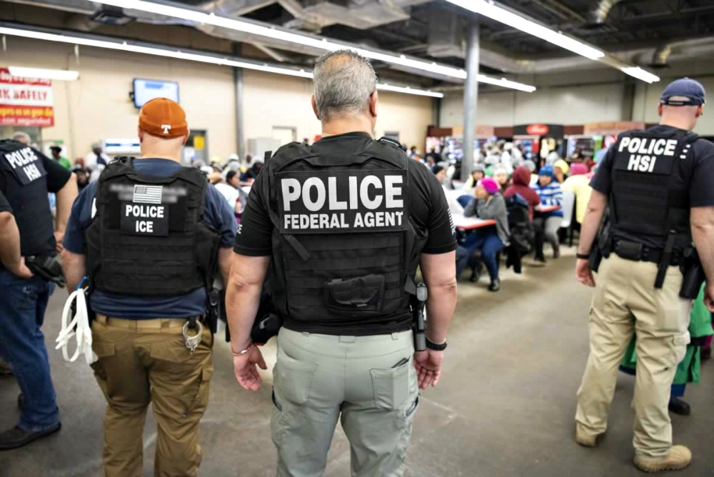 U.S. Immigration and Customs Enforcement officers look on after executing search warrants and making arrests Aug. 7 at an agricultural processing facility in Canton, Mississippi. (CNS/Immigration and Customs Enforcement handout via Reuters)