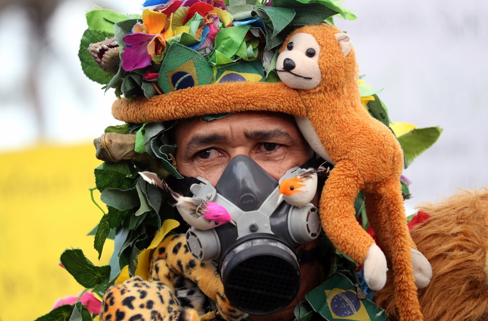 An Amazon rainforest advocate is seen wearing a gas mask in Rio de Janeiro Aug. 25. (CNS/Reuters/Sergio Moraes) An Amazon rainforest advocate is seen wearing a gas mask in Rio de Janeiro Aug. 25. (CNS/Reuters/Sergio Moraes)