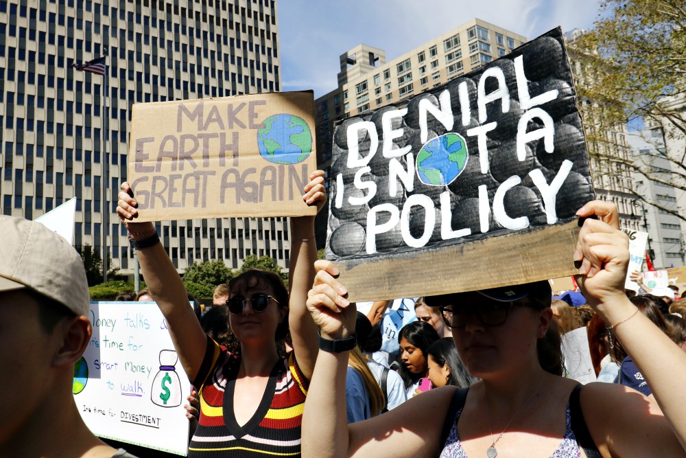 Young women hold signs while participating in the Global Climate Strike in New York City Sept. 20. (CNS/Gregory A. Shemitz)