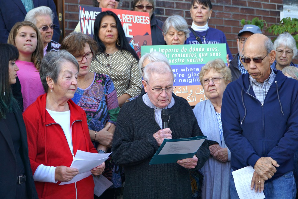 Fr. Jim Flynn, a retired priest of the Archdiocese of Louisville, Kentucky, reads a portion of a statement Oct. 8, 2019, at St. William Church that reaffirmed the parish’s commitment as a sanctuary church. (CNS/The Record/Jessica Able)