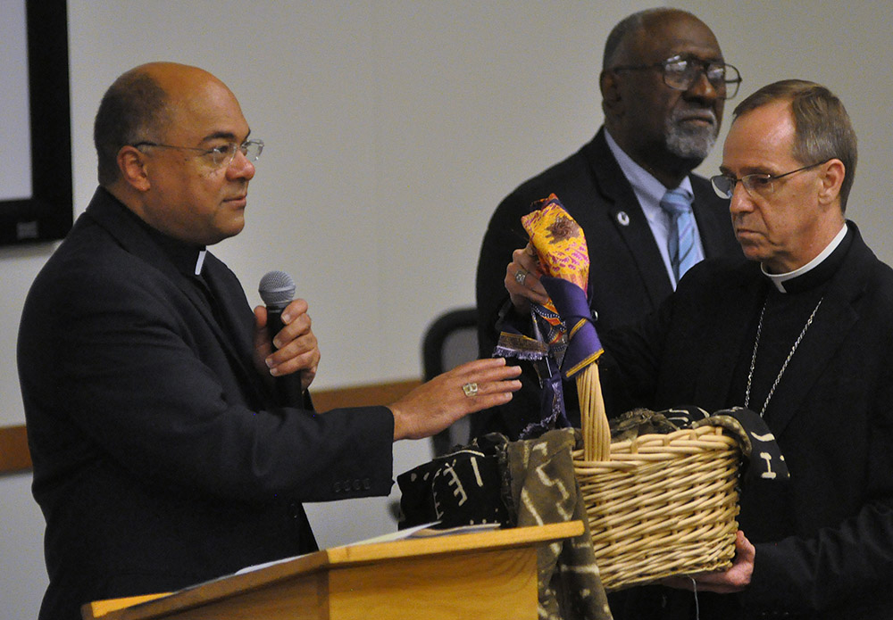 During a 2019 listening session on racism in Indianapolis, Bishop Shelton Fabre of Houma-Thibodaux, Louisiana, blesses a basket (held by Indianapolis Archbishop Charles Thompson) containing people's written accounts of experiences of racism. (CNS) During a 2019 listening session on racism in Indianapolis, Bishop Shelton Fabre of Houma-Thibodaux, Louisiana, blesses a basket (held by Indianapolis Archbishop Charles Thompson) containing people's written accounts of experiences of racism. (CNS)