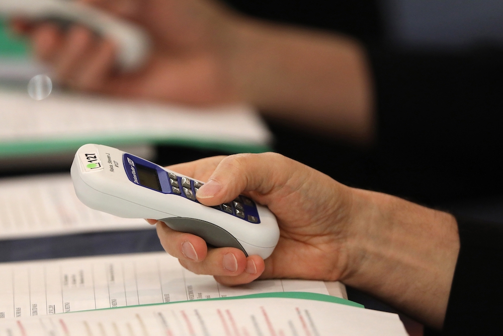 Bishops use electronic voting devices during the spring general assembly of the U.S. Conference of Catholic Bishops June 12, 2019, in Baltimore. During the 2021 virtual spring assembly, bishops voted by secret ballot June 17 to draft a document to address