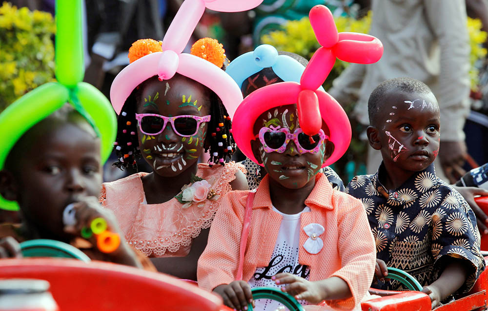 Children in Nairobi, Kenya, ride on a makeshift train Dec. 25, 2019, during Christmas celebrations. (CNS/Reuters/Njeri Mwangi)