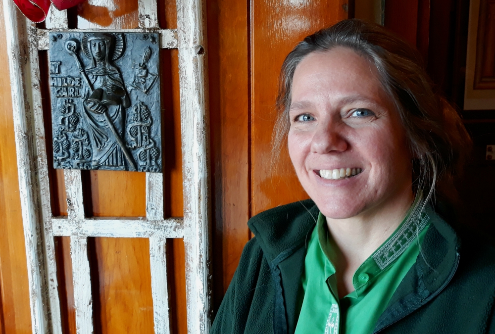 Shanon Sterringer is seen alongside an image of St. Hildegard of Bingen at Hildegard Haus, the church community she leads as a Roman Catholic woman priest in Fairport Harbor, Ohio. (Don Clemmer)