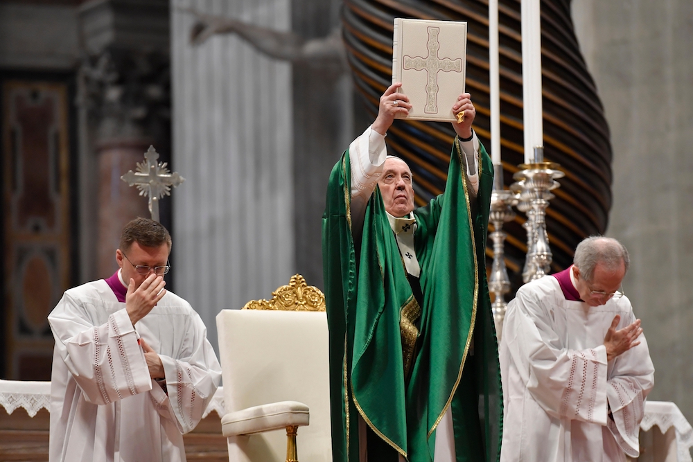 Pope Francis holds up the Lectionary (or book of Mass readings) that was used during the Second Vatican Council, Jan. 26, 2020,  in St. Peter's Basilica, the first Sunday of the Word of God, encouraging Catholics to read the Bible. (CNS/Vatican Media)