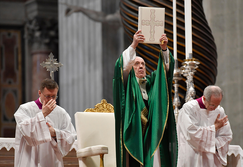 Pope Francis holds up the Lectionary, or book of Mass readings, that was used during the Second Vatican Council. (CNS/Vatican Media)