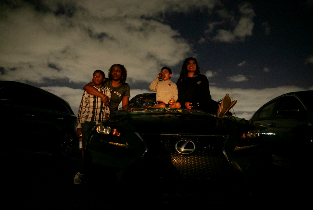 People in Fort Lauderdale, Florida, watch a movie at a drive-in theater during the coronavirus pandemic March 28. (CNS/Reuters/Marco Bello) People in Fort Lauderdale, Florida, watch a movie at a drive-in theater during the coronavirus pandemic March 28. (CNS/Reuters/Marco Bello)