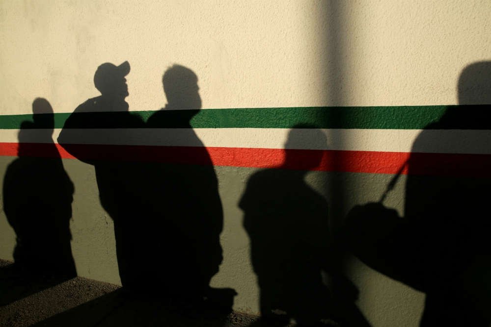 Immigrants in Ciudad Juárez, Mexico, cast shadows on a National Institute of Migration building after they were deported from the United States April 21 during the coronavirus pandemic. (CNS/Reuters/Jose Luis Gonzalez) Immigrants in Ciudad Juárez, Mexico, cast shadows on a National Institute of Migration building after they were deported from the United States April 21 during the coronavirus pandemic. (CNS/Reuters/Jose Luis Gonzalez)