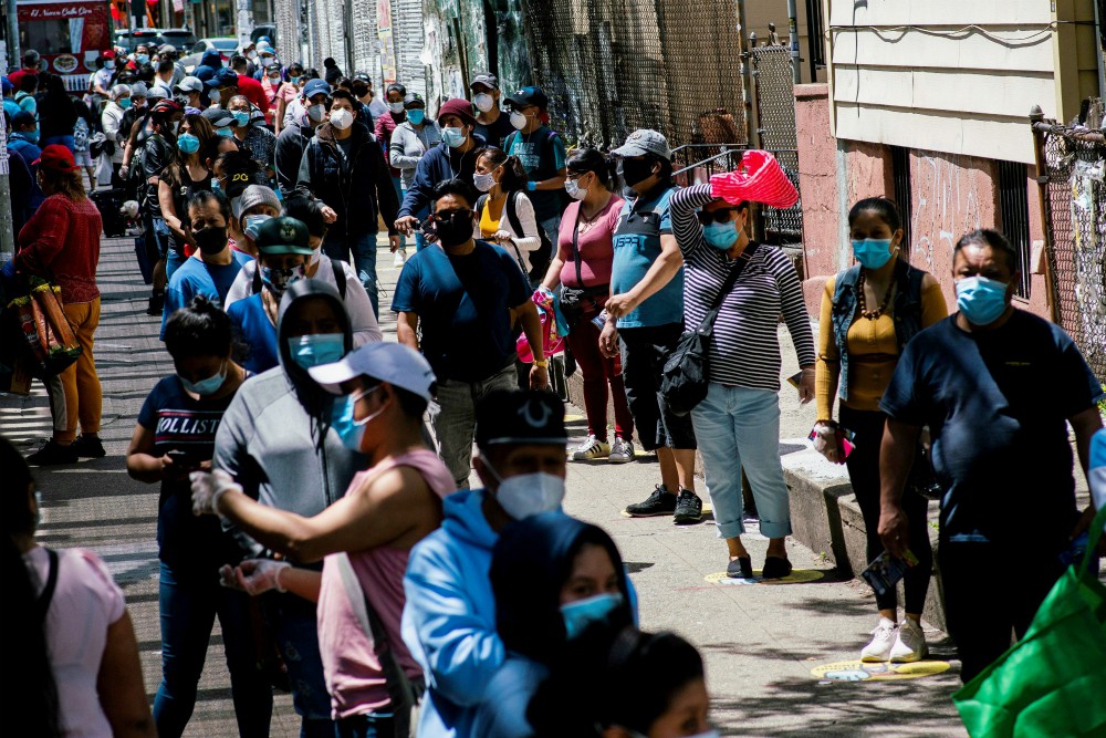 People in the Queens borough of New York City line up during a food distribution May 16. (CNS/Reuters/Eduardo Munoz)