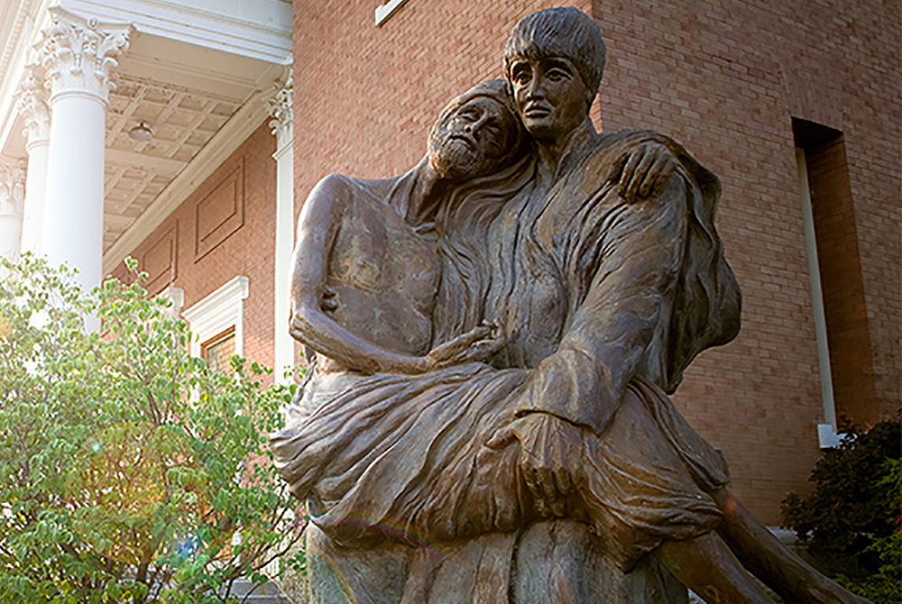 Statue of St. Aloysius Gonzaga at Gonzaga University A statue of St. Aloysius Gonzaga carrying a plague victim in his arms is seen on the campus of Gonzaga University in Spokane, Wash., in this undated photo. (CNS/Courtesy of Gonzaga University)