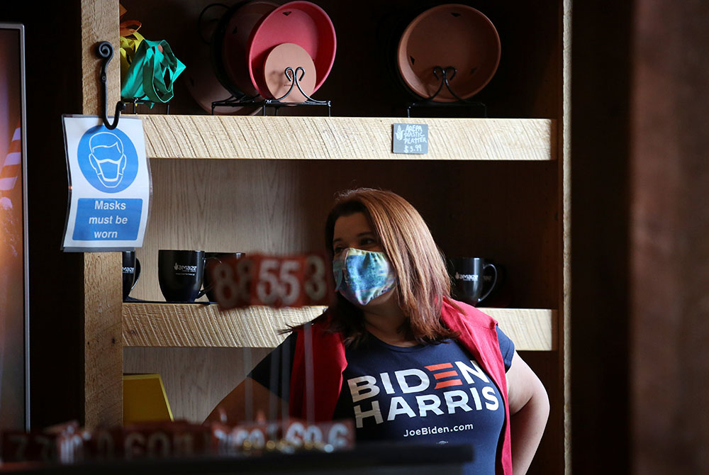 A woman in a Miami restaurant listens to Democratic vice presidential candidate Sen. Kamala Harris during a campaign event Sept. 10. Miami is a majority Latino city, with Hispanics making up 70% of its population of about 471,000. (CNS/Marco Bello, Reuter