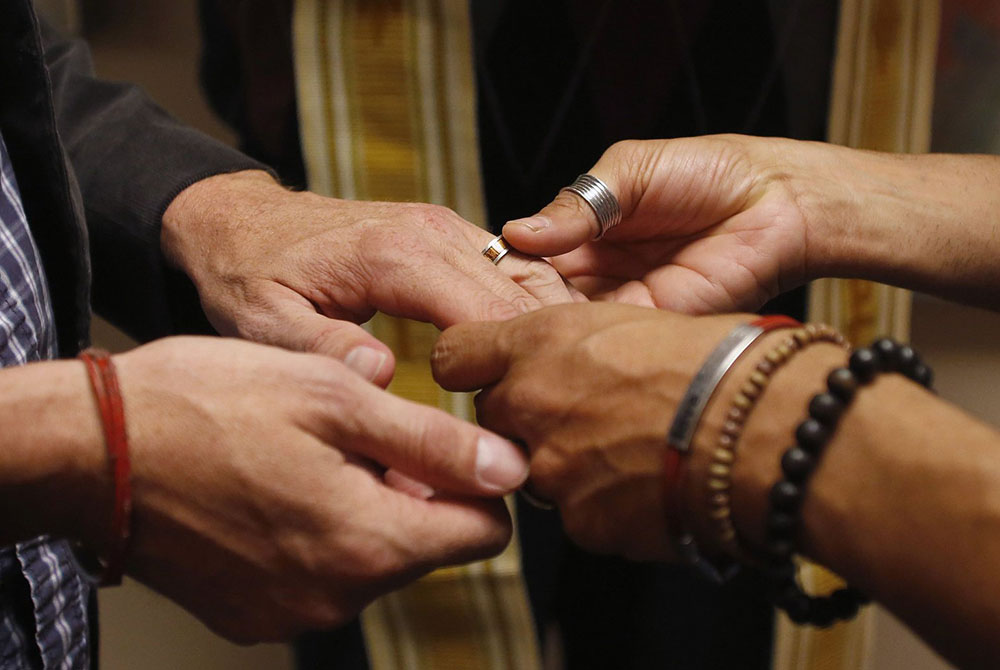 A same-sex couple is pictured in a file photo exchanging rings during a ceremony in Salt Lake City. In a new documentary, Pope Francis expressed openness to the idea of laws recognizing civil unions, including for gay couples, to protect their rights. (CN A same-sex couple is pictured in a file photo exchanging rings during a ceremony in Salt Lake City. In a new documentary, Pope Francis expressed openness to the idea of laws recognizing civil unions, including for gay couples, to protect their rights. (CN