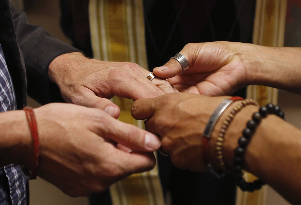 A file photo shows a same-sex couple exchanging rings during a ceremony in Salt Lake City. (CNS/Reuters/Jim Urquhar)