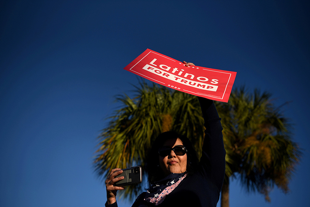 A Latina voter holds up a sign in support of President Donald Trump as voters line up at a polling station on Election Day in Houston Nov. 3. (CNS/Reuters/Callaghan O'Hare) A Latina voter holds up a sign in support of President Donald Trump as voters line up at a polling station on Election Day in Houston Nov. 3. (CNS/Reuters/Callaghan O'Hare)