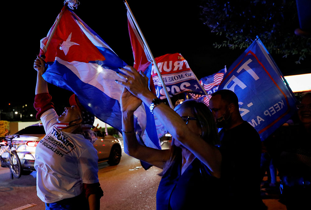 A supporter of President Donald Trump holds a Cuban flag in Miami during the presidential election Nov. 3, 2020. (CNS/Reuters/Marco Bello) A supporter of President Donald Trump holds a Cuban flag in Miami during the presidential election Nov. 3, 2020. (CNS/Reuters/Marco Bello)