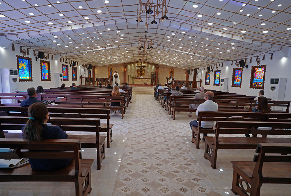 People maintain social distancing while attending Mass at a church in Mosul, Iraq, Nov. 1, 2020, during the COVID-19 pandemic. Pope Francis plans to visit Iraq March 5-8, 2021. (CNS/Reuters/Abdullah Rashid)