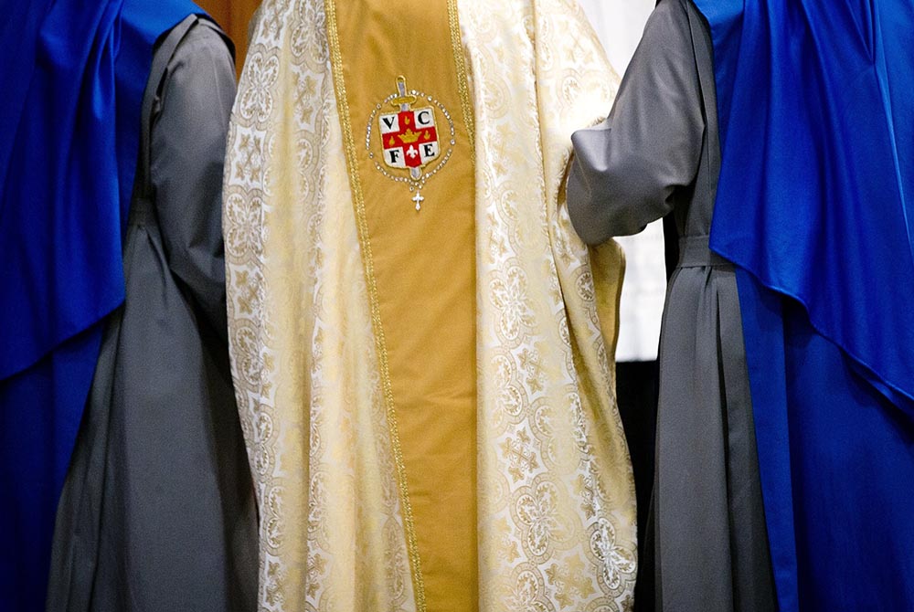 Sisters of the Servants of the Lord and the Virgin of Matara help then-Cardinal Theodore McCarrick walk through Holy Comforter-St. Cyprian Catholic Church in Washington after the ceremony for their profession of vows Nov. 1, 2017, in Washington. (CNS/Tyle Sisters of the Servants of the Lord and the Virgin of Matara help then-Cardinal Theodore McCarrick walk through Holy Comforter-St. Cyprian Catholic Church in Washington after the ceremony for their profession of vows Nov. 1, 2017, in Washington. (CNS/Tyle